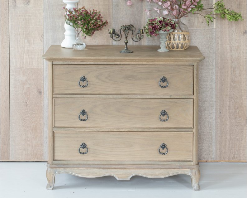 Wooden dresser with decorative items against a wooden wall.