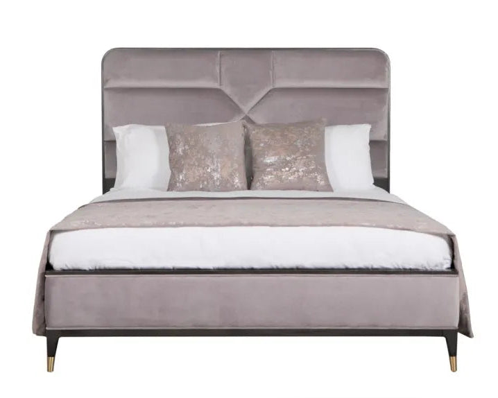Gray upholstered bed with decorative pillows on a white background