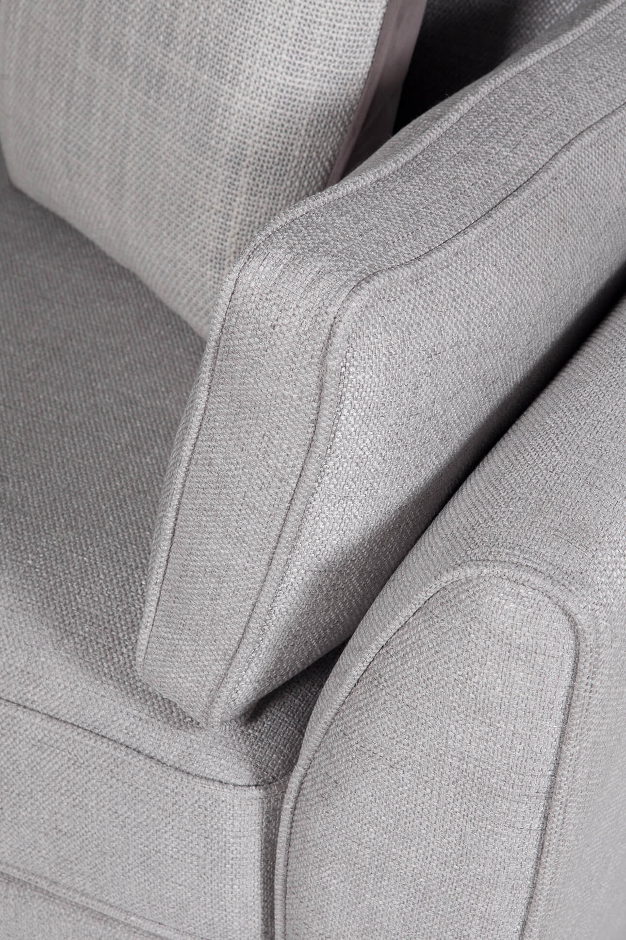 Close-up of a gray upholstered chair with visible stitching