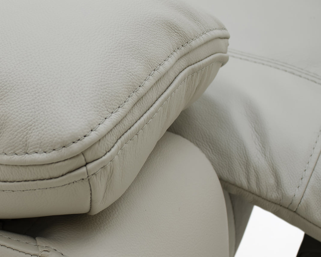 Close-up of the Positano leather upholstery, stitching and padded armrest.