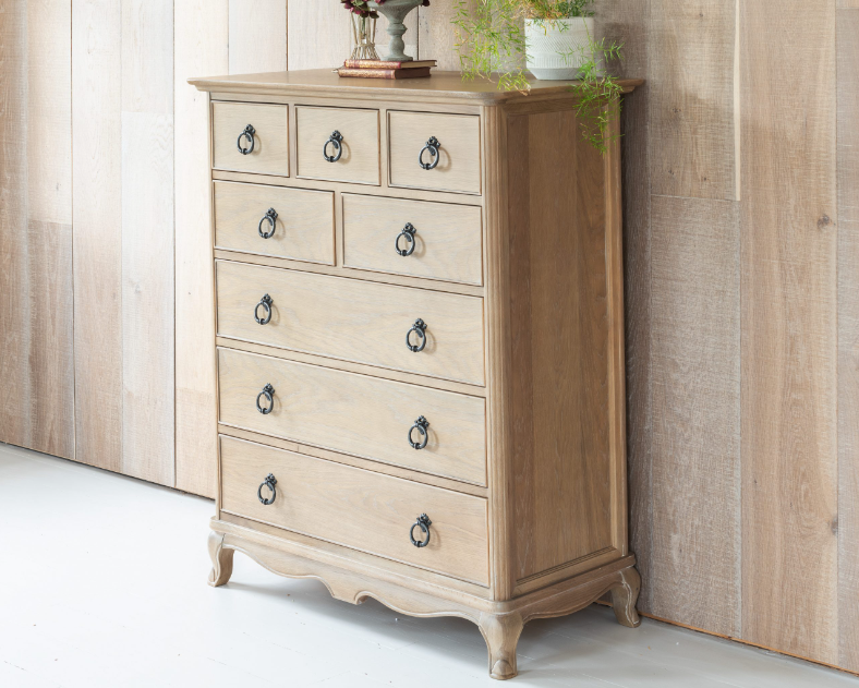 Wooden dresser with decorative items against a wooden wall.