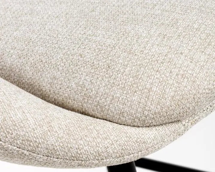 Close-up of a textured beige chair seat on a white background