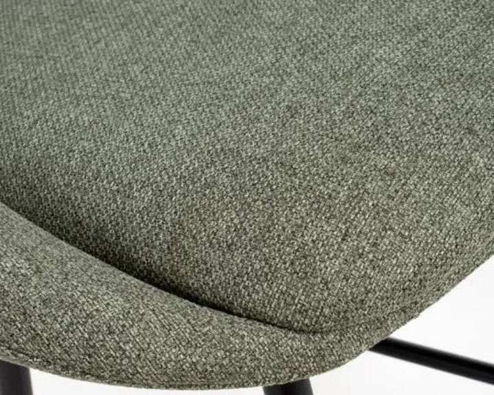 Close-up of a green textured chair seat on a white background