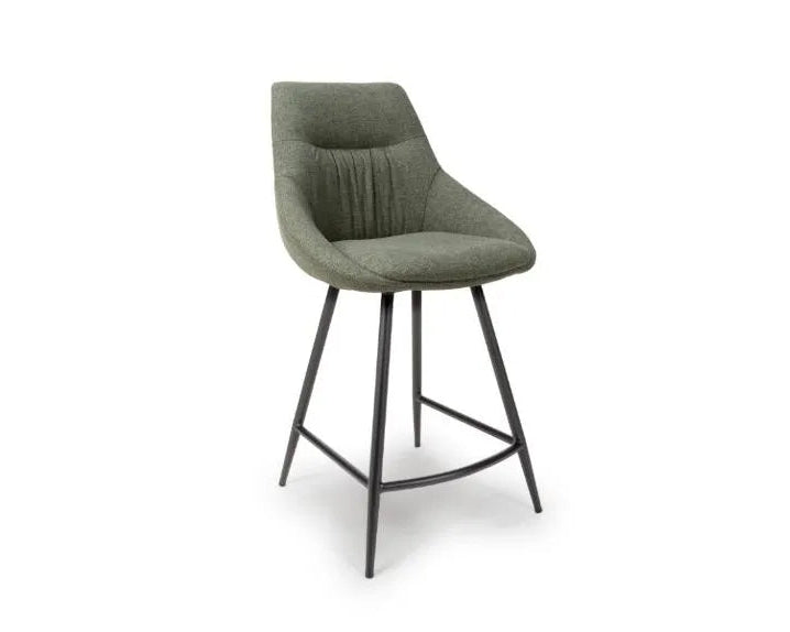 Green bar stool with black legs on a white background