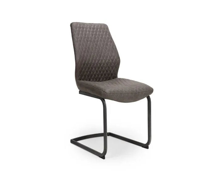 A modern dining chair with a quilted gray upholstered seat and backrest, supported by a black cantilever metal base, shown against a plain white background.