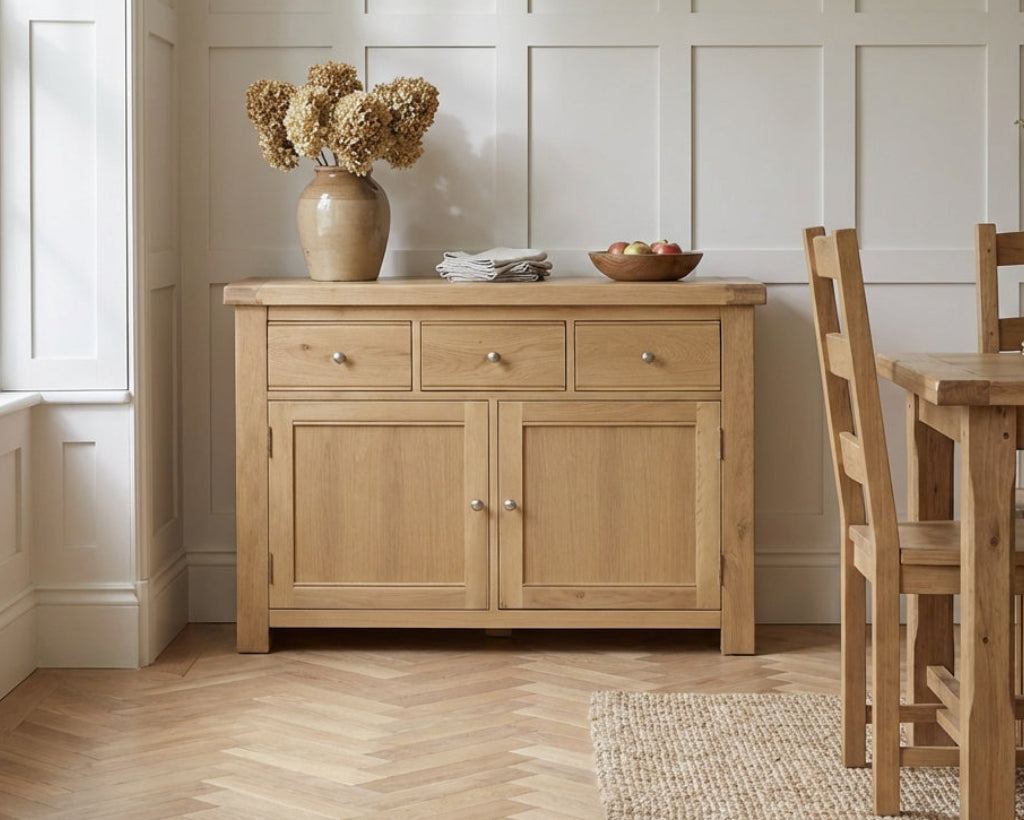 Wooden sideboard with decorative items in a room with a dining table and chairs.