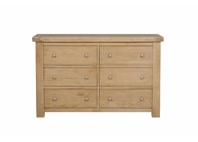 Wooden dresser with six drawers on a white background