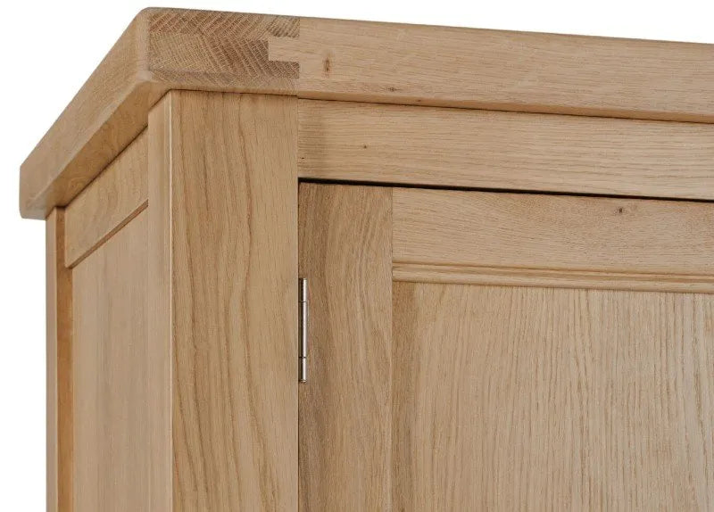 Close-up of a wooden cabinet with a visible hinge.