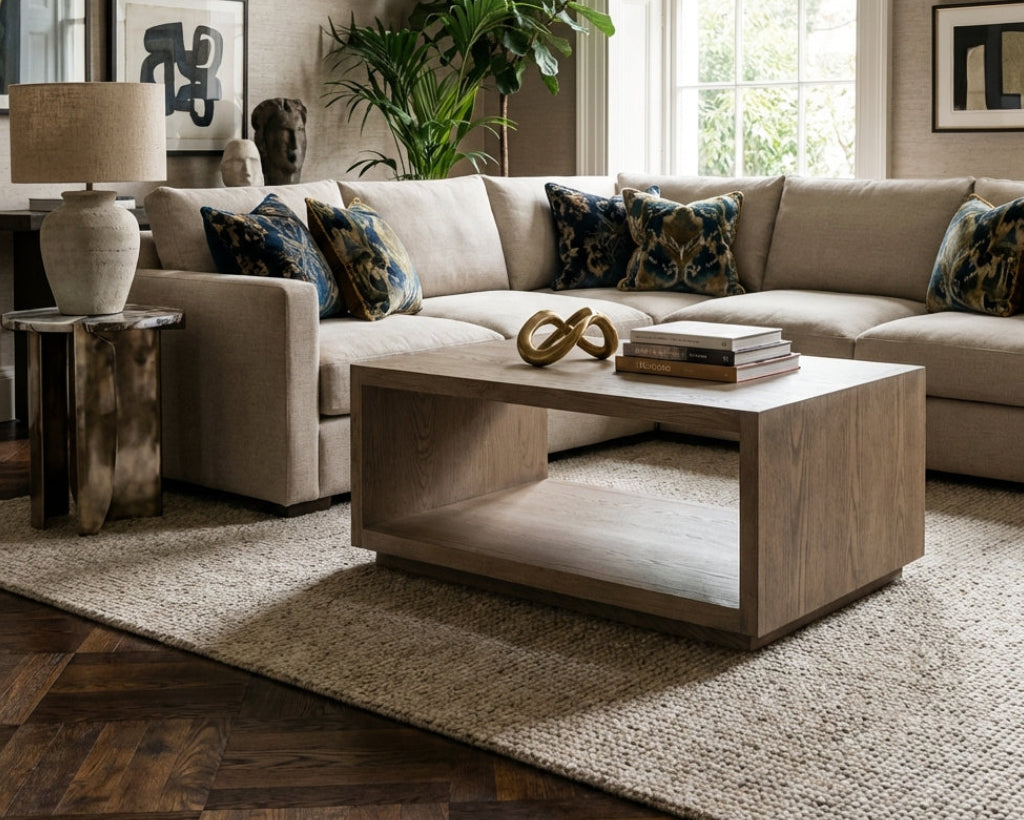 Living room with beige sectional sofa, wooden coffee table, and decorative elements.