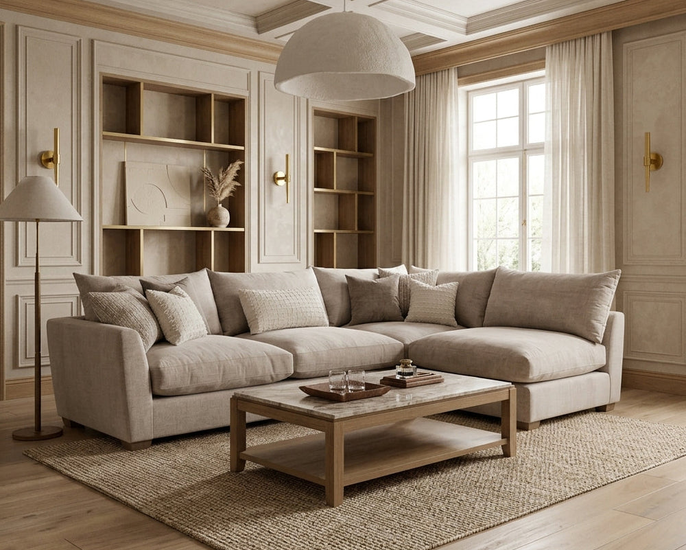 Modern living room with a beige sectional sofa, wooden coffee table, and bookshelves.
