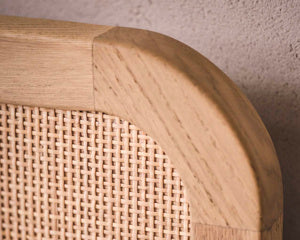 Close-up of a wooden headboard with woven design