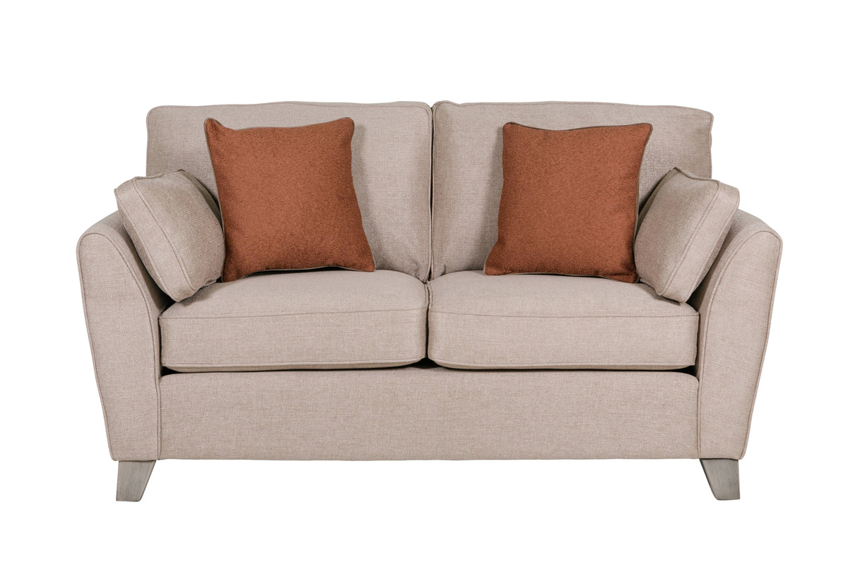 Beige sofa with two brown cushions on a white background