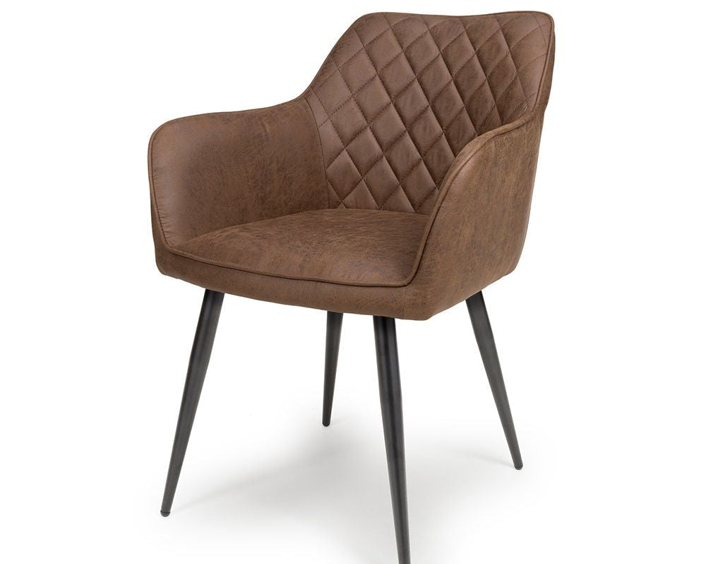 Brown quilted armchair with black legs on a white background
