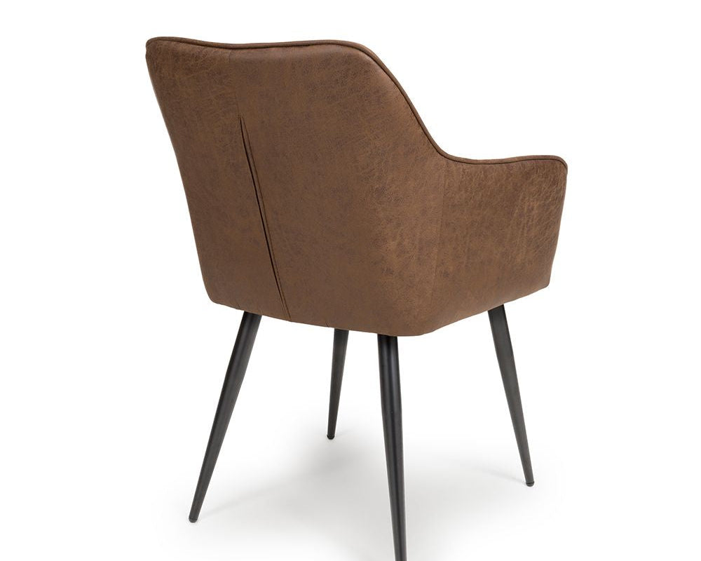 Brown upholstered chair with black legs on a white background