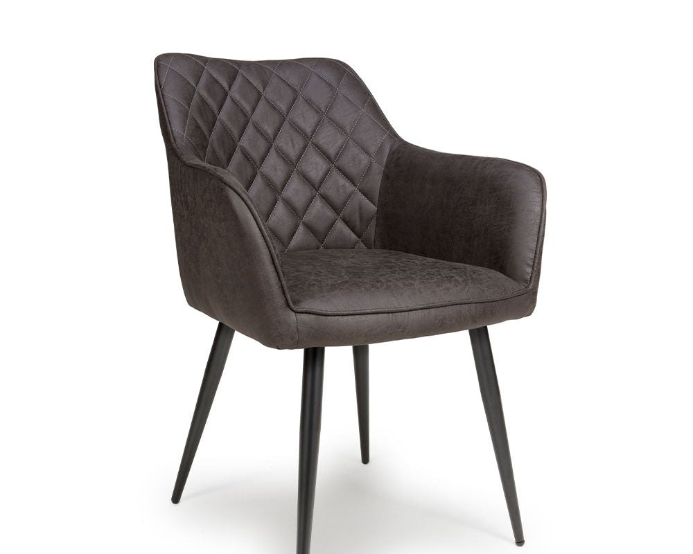 Brown quilted armchair with black metal legs on a white background