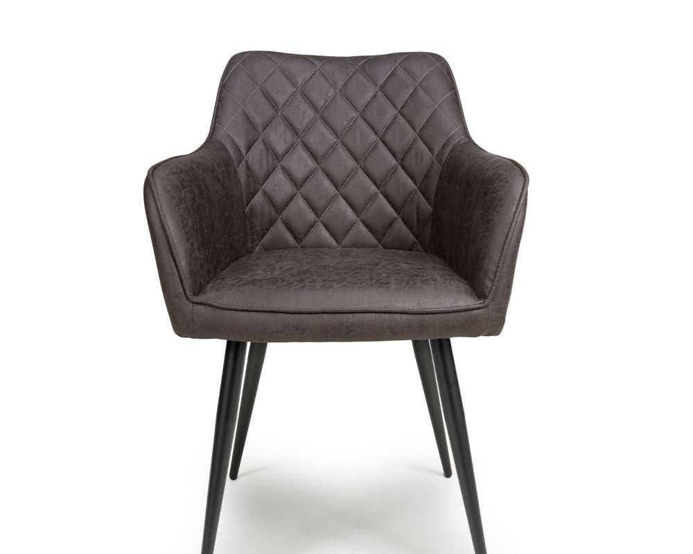 Gray quilted armchair with black legs on a white background