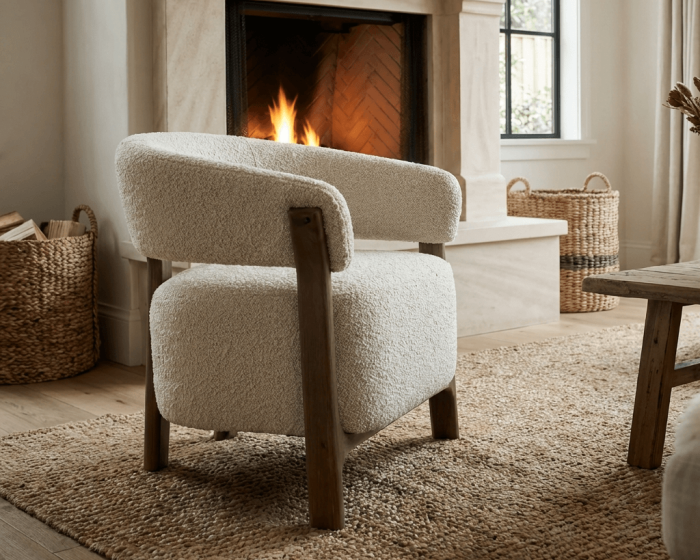 Cozy living room with a fireplace, armchair, and baskets.