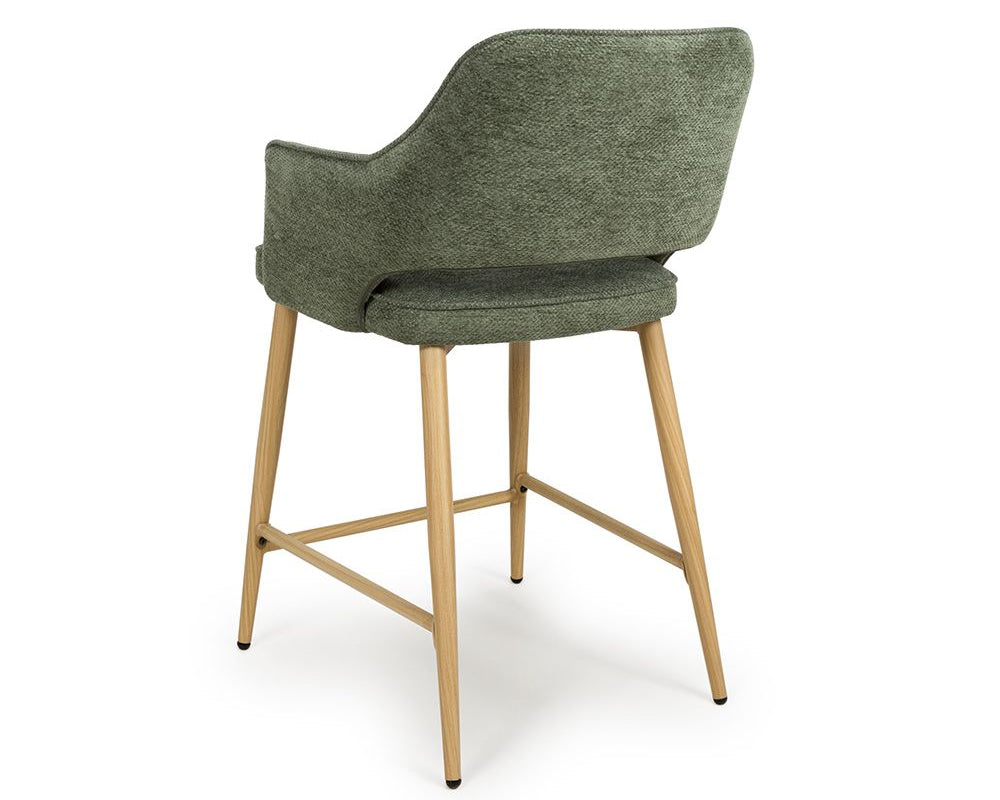 Green bar stool with wooden legs on a white background