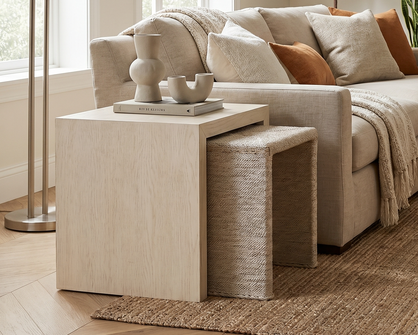 harmony nesting tables styled beside sofa in neutral living room with oak and woven textures