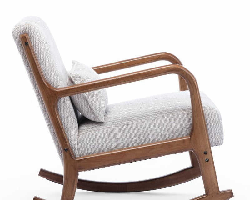 A modern wooden rocking chair with light gray textured fabric upholstery and a matching throw pillow, shown on a clean white background.
