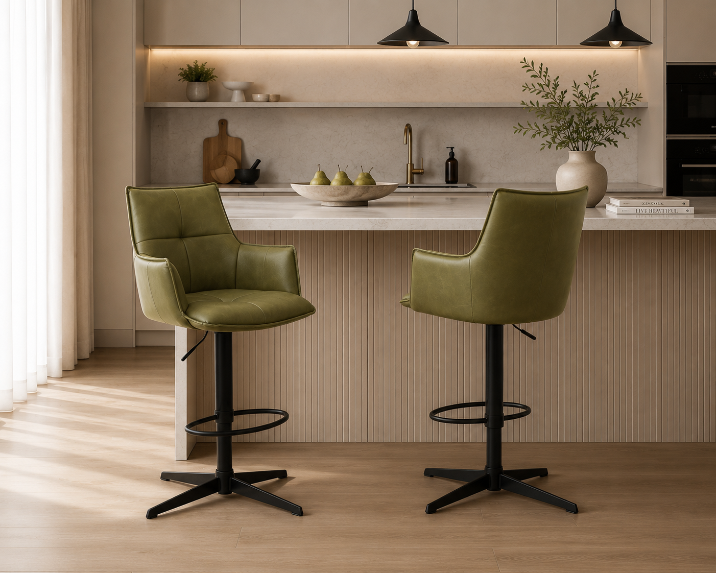 Two green bar stools with black bases in a modern kitchen setting.