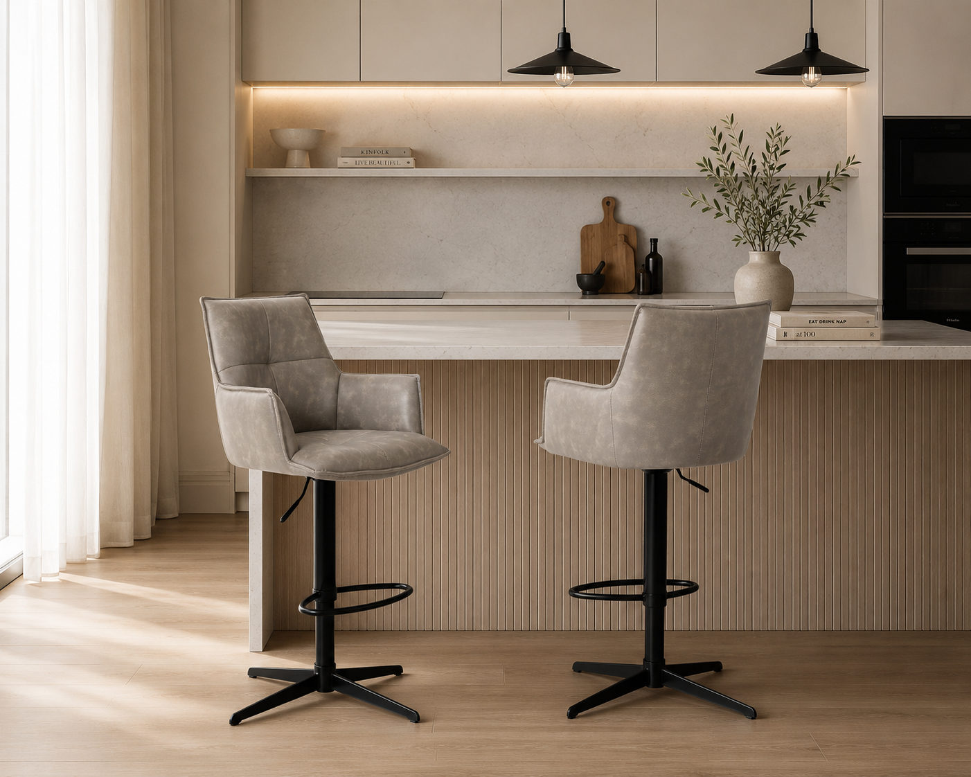 Modern kitchen with bar stools and a countertop.