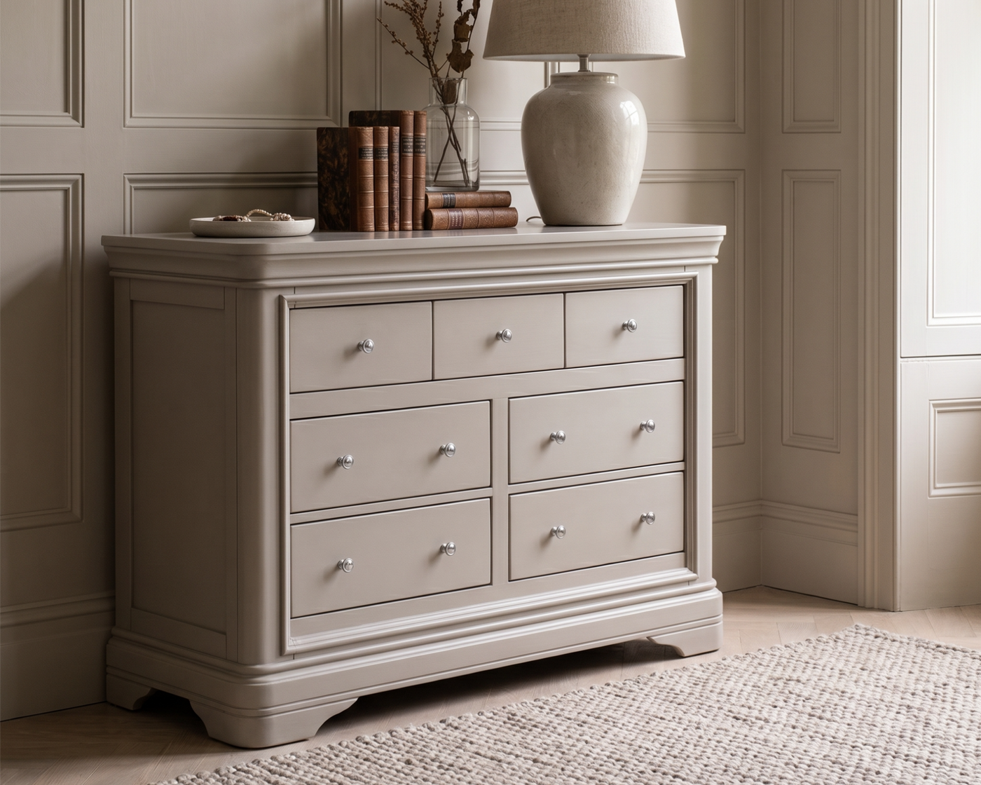 Beige dresser with decorative items against a neutral wall
