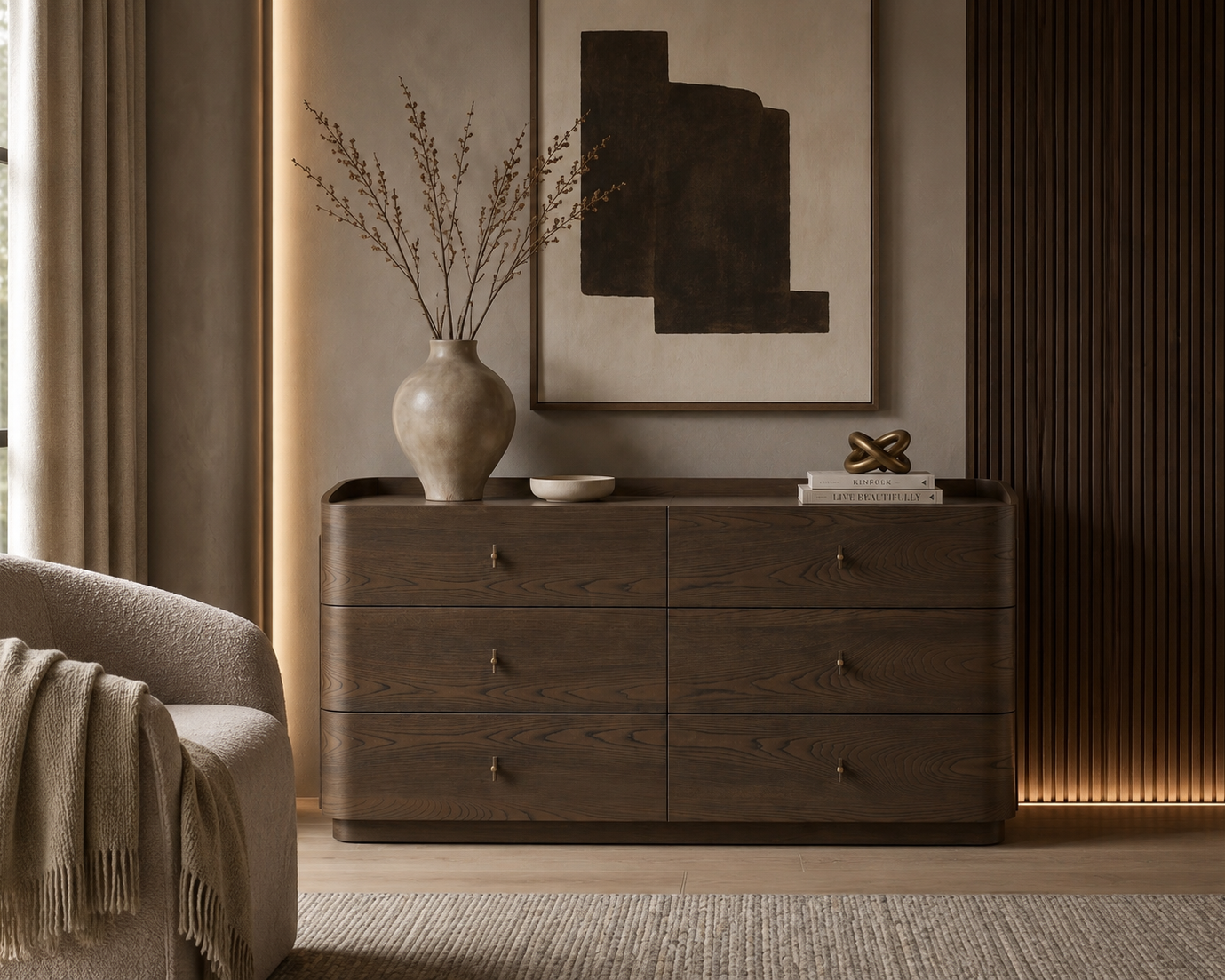 A dark brown wooden six-drawer dresser in a modern, warm-toned living room setting, styled with a ceramic vase, dried branches, and a small decorative sculpture.