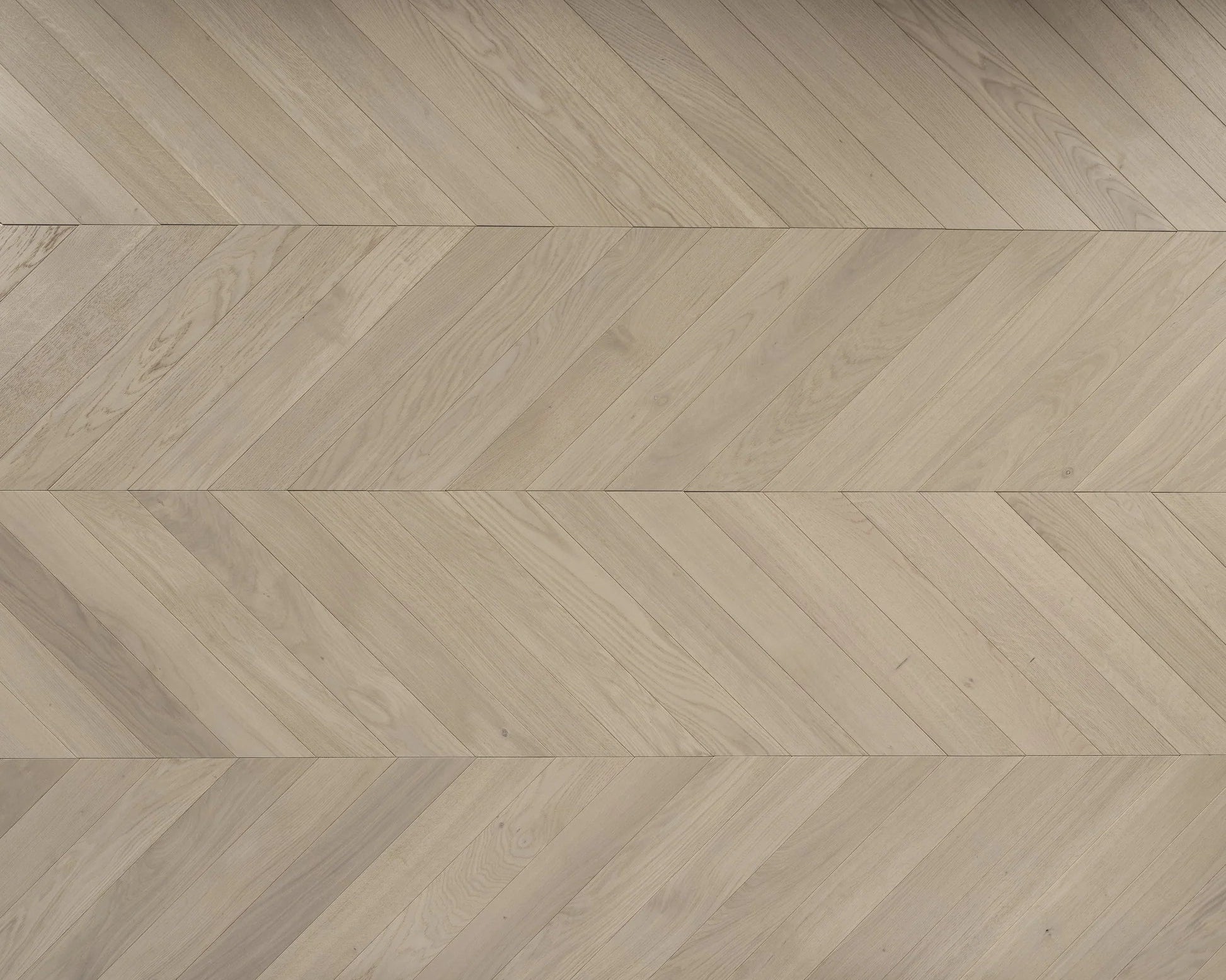 Misty grey chevron engineered oak flooring installed in a modern UK interior