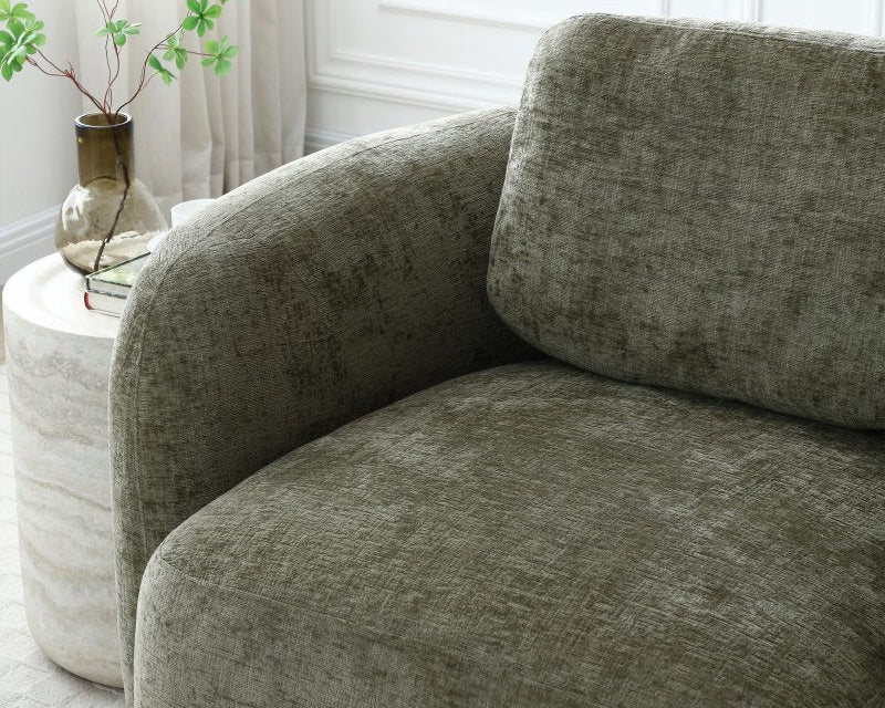 Gray sofa in a room with a white side table and plant