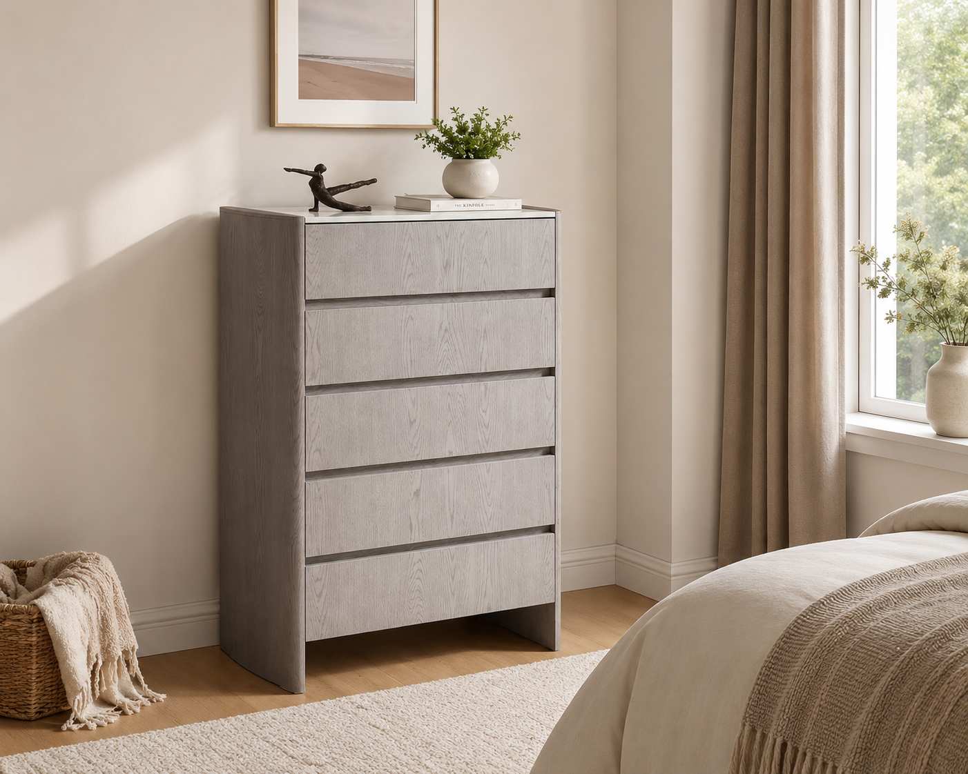 A tall light gray wood-grain chest of drawers with five drawers, styled in a bright, modern bedroom next to a bed and window.