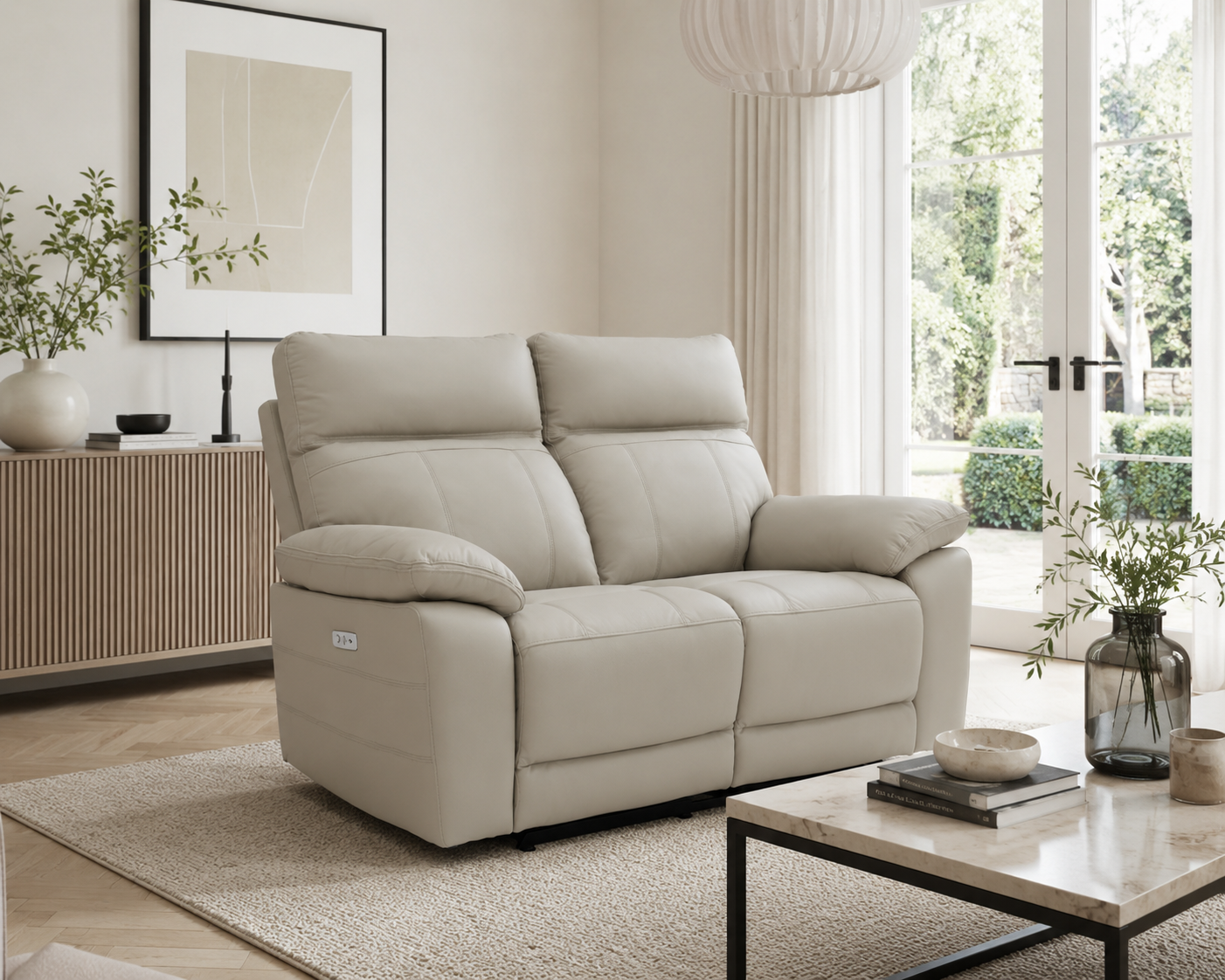 Positano 2 Seater Electric Recliner Sofa in light grey leather styled in a bright contemporary living room.