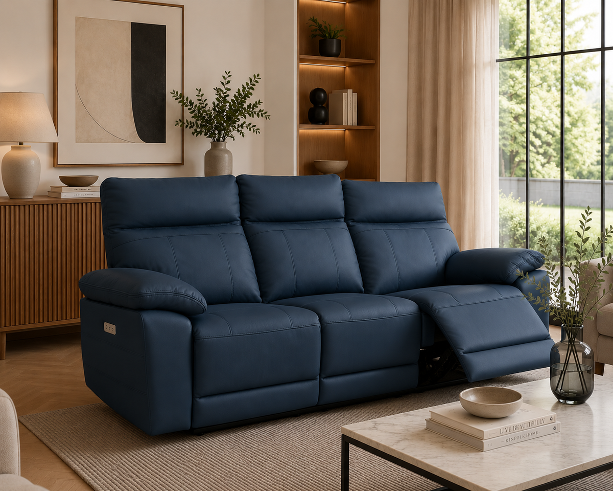 Positano 3 Seater Electric Reclining Leather Sofa in Indigo with one seat fully reclined in a bright contemporary living room.