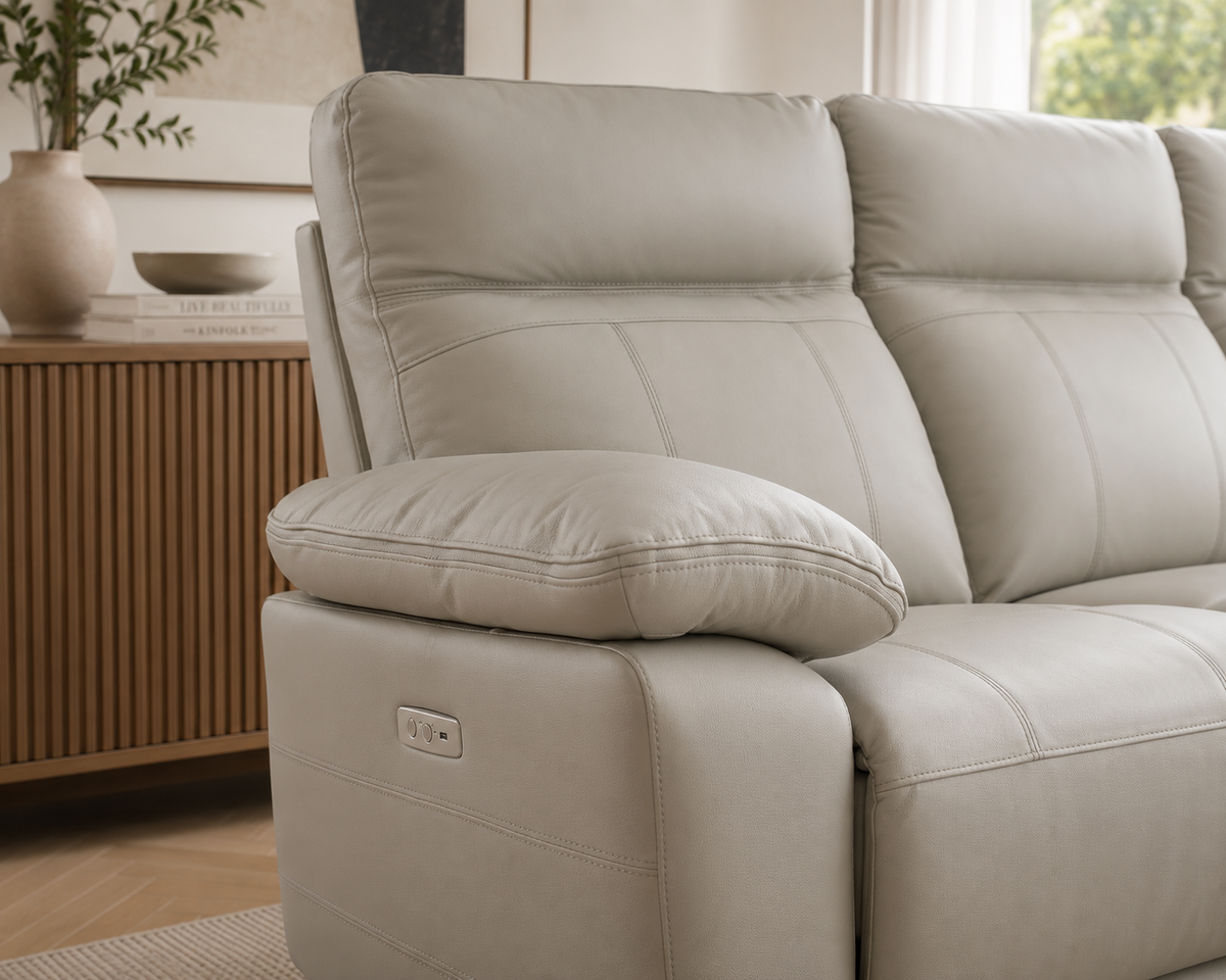Close-up of the Positano 3 Seater Electric Reclining Leather Sofa in light grey, highlighting the premium leather upholstery, supportive armrest and detailed stitching.