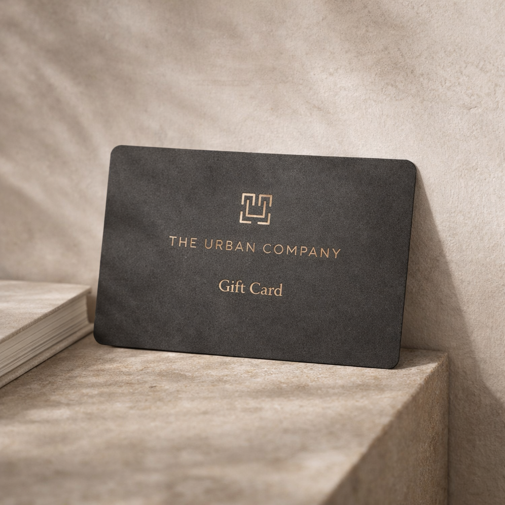 Black gift card from The Urban Company on a textured surface